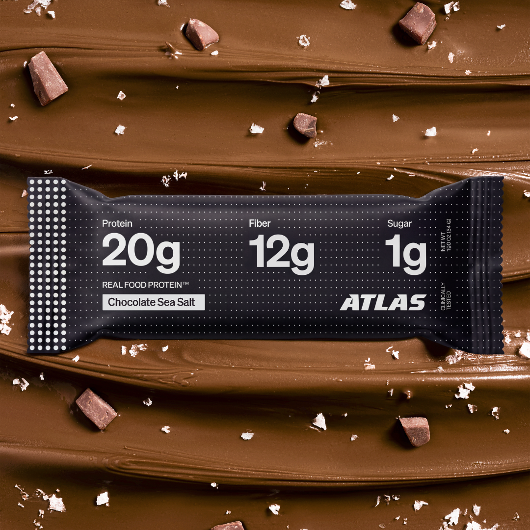 Atlas Chocolate Sea Salt bar on a dark chocolate and sea salt background