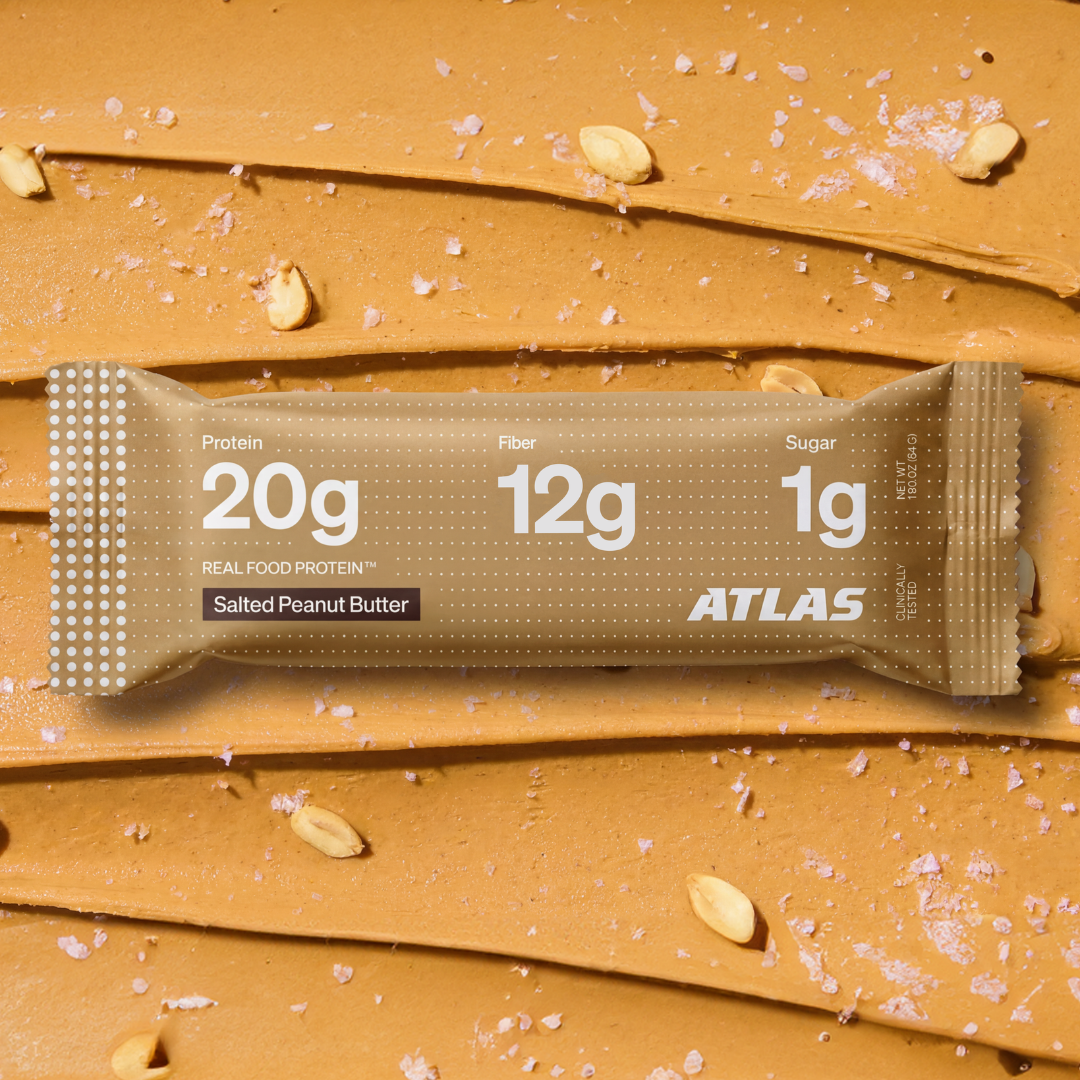 Atlas Salted Peanut Butter bar on a peanut butter and sea salt background