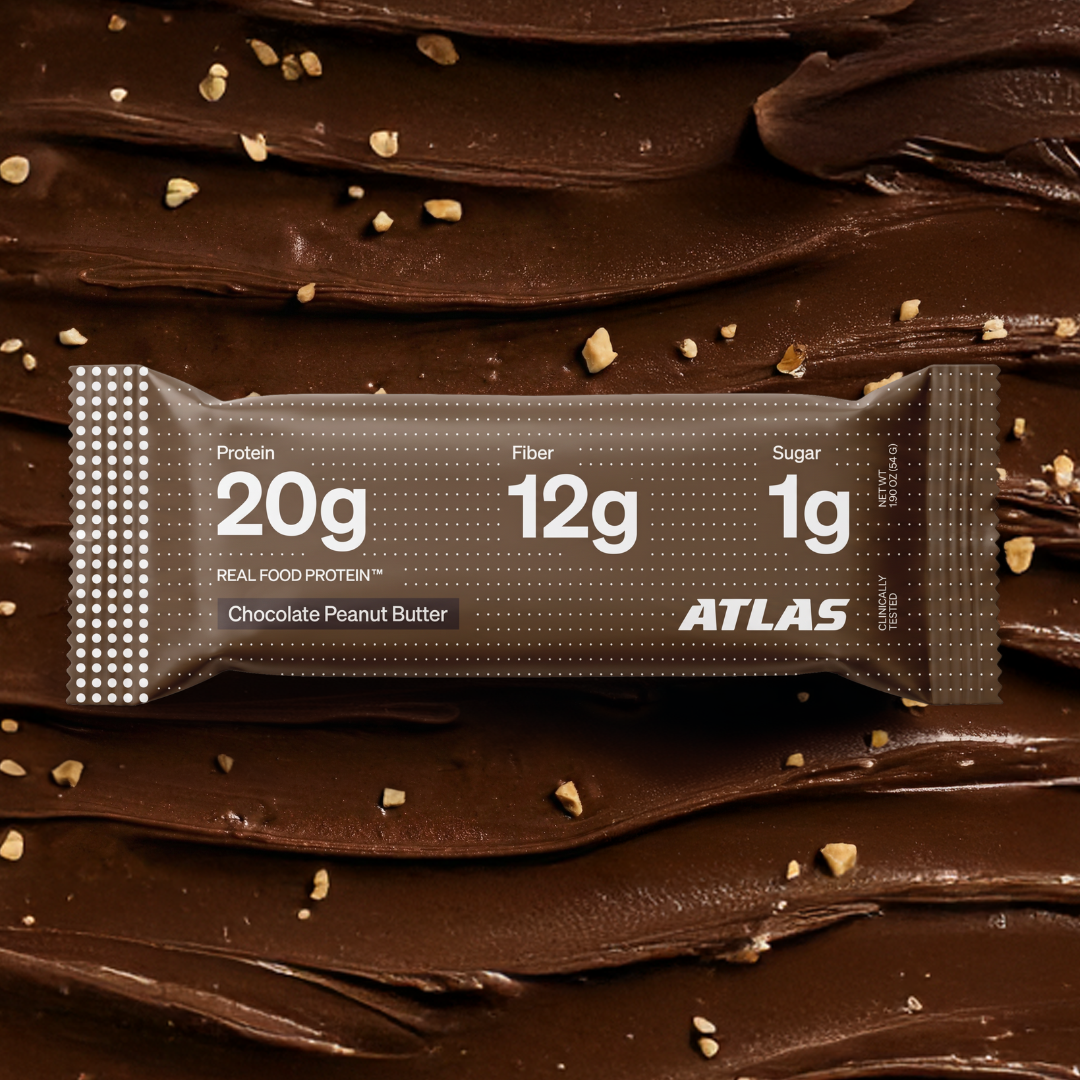 Atlas Chocolate Peanut Butter bar on a chocolate peanut butter background