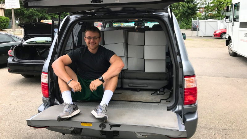 James Oliver sitting in car with first shipment of atlas bars