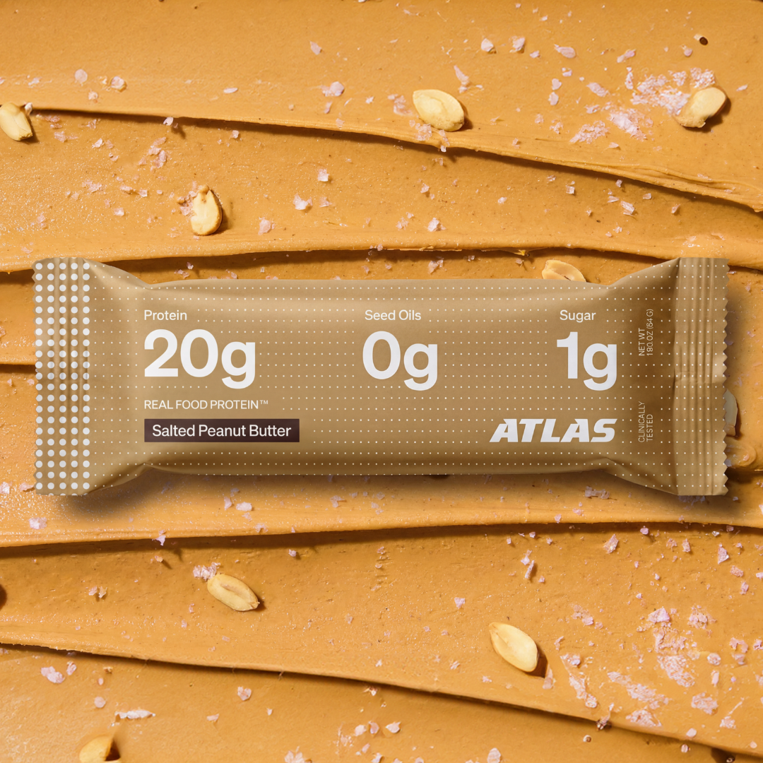 Atlas Salted Peanut Butter bar on a salted peanut butter background