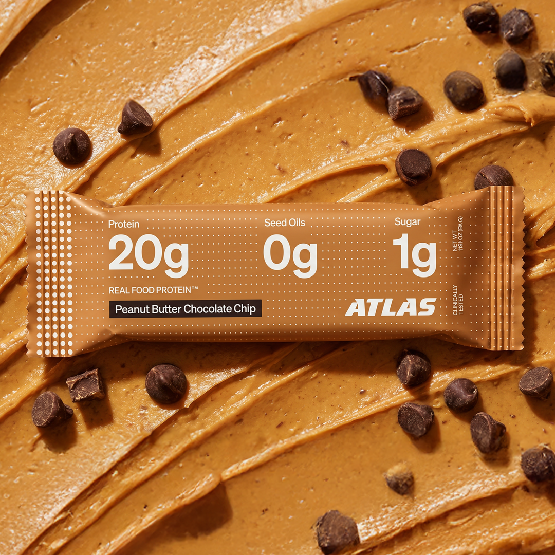 Peanut Butter Chocolate Chip Atlas Bar on a peanut butter and chocolate background